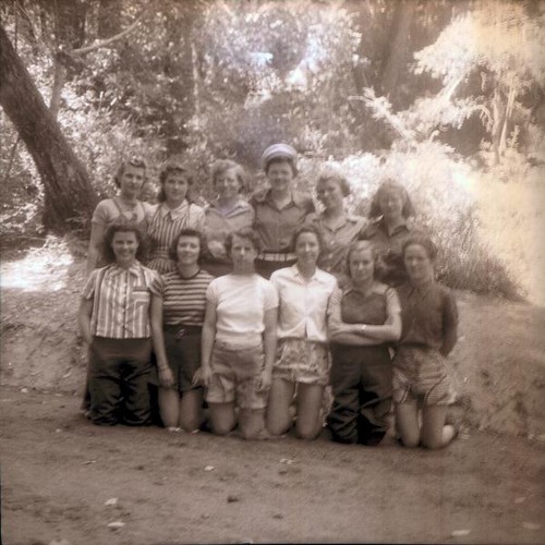 Teenage girls posing for a picture in the woods