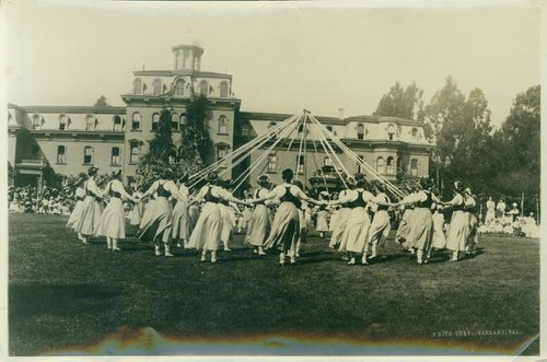 Women gathered around a maypole