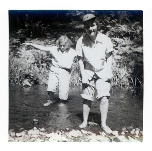 Teenager girls wading through a stream