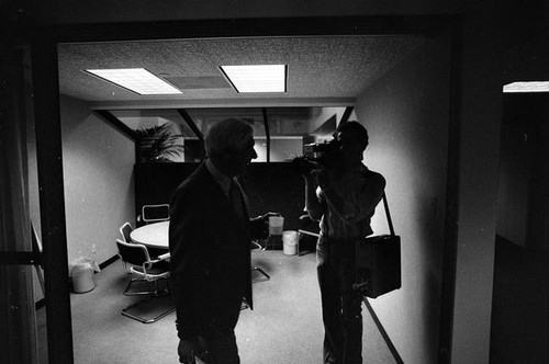 Man being filmed in a conference room