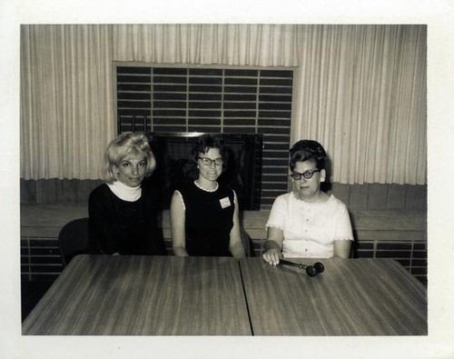 Three women sitting at tables