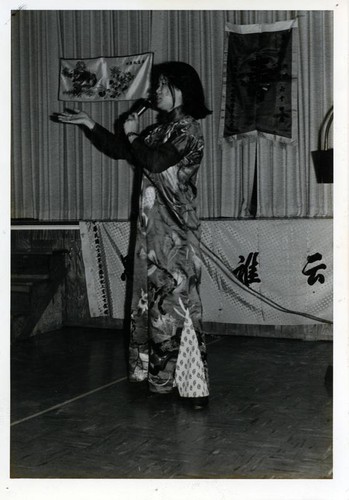 Asian appearing women speaking into a microphone