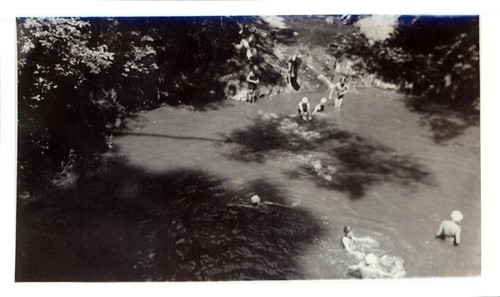 Swimmers at an outdoor swimming hole