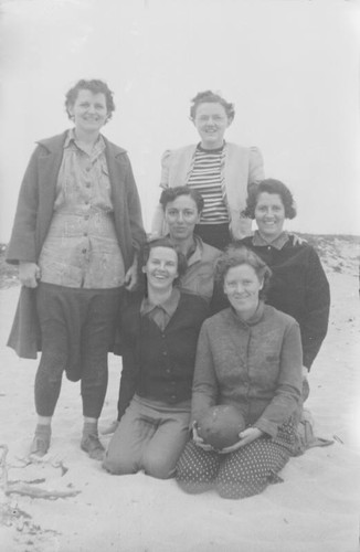 Women posing on a beach