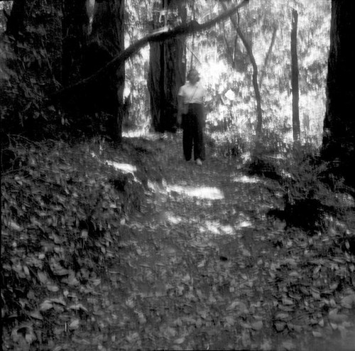 Teenage girl walking down a forested path