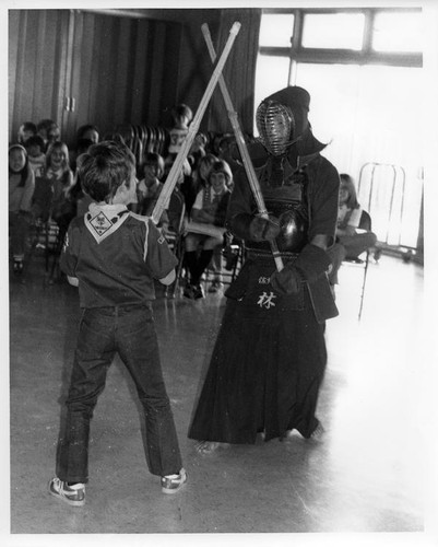 Cub scout and a man in kendo clothing