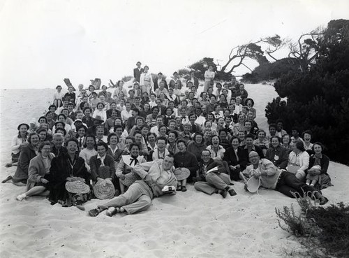 Large group portrait of women, men and a baby