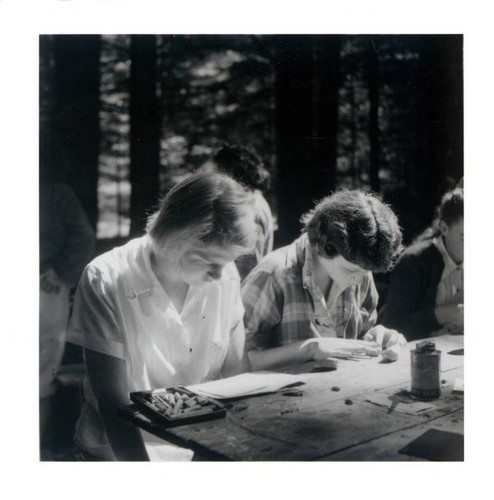 Teenage girls working at a picnic table
