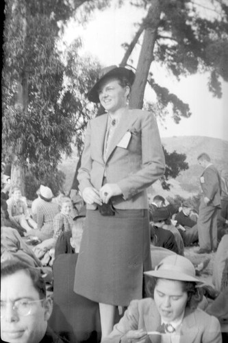 Unknown woman dressed in business attire standing outdoors