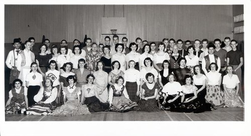 Group portrait of people wearing clothing from various nations and cultures