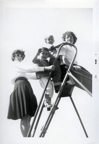 Two small boys and two teenagers on a slide