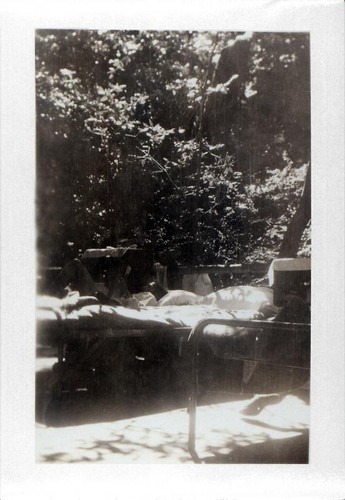 Teenage girl relaxing on a bed outdoors