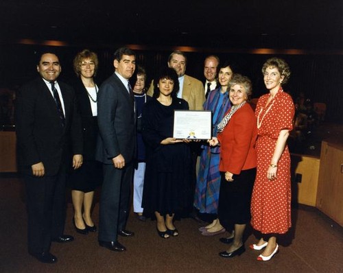 Group portrait with women holding a proclamation