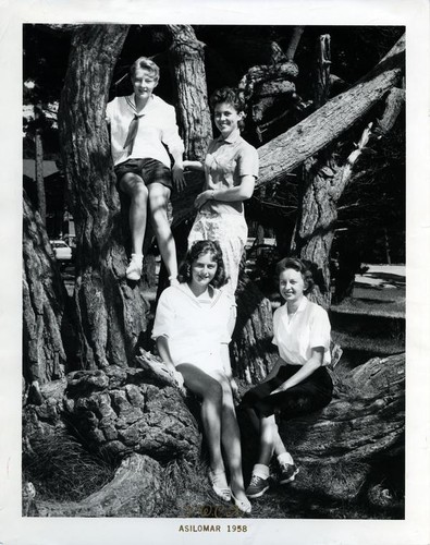 Four teenage girls posing on a cypress tree in Asilomar