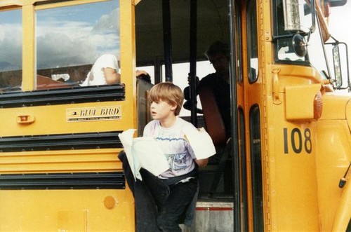 Boy exiting a school bus