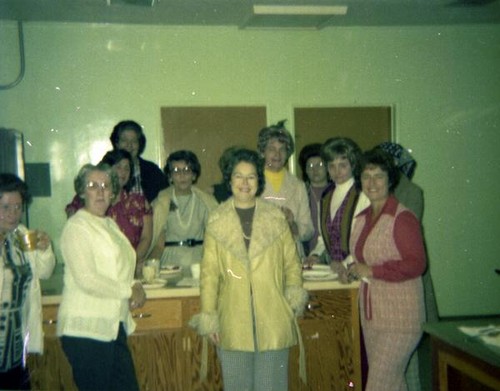 Women posing at a counter