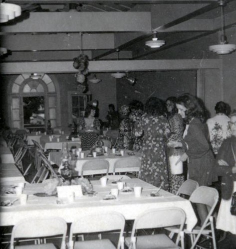 Women milling around a dining area