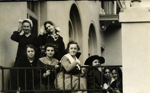 Group of youth posing outside along a railing