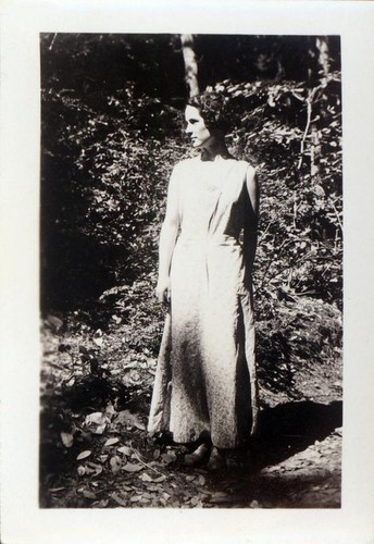 Woman posing in front of a small tree