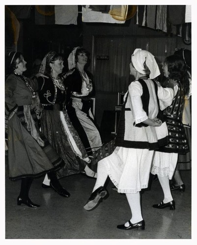 Six women dancing in traditional folk attire