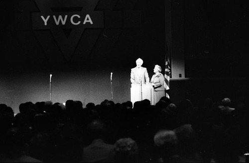 Man and woman at podium