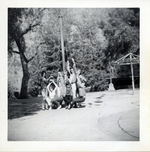 Teenage girls posing on playground equipment