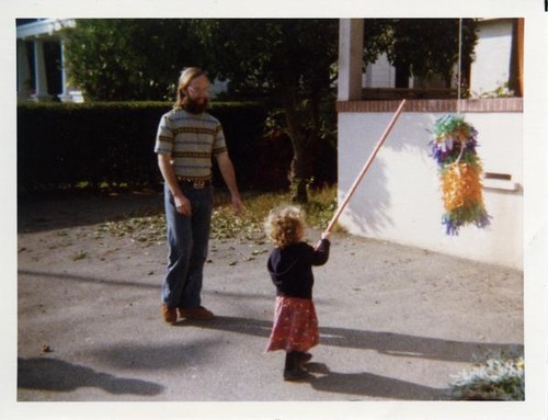 Little girl prepares to hit a pinata