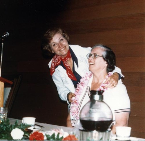 Susanne B. Wilson places a lei on Lois Cullison