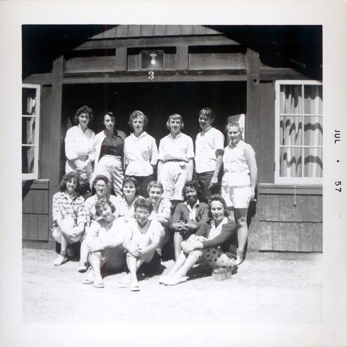 Group of women posing in a large doorway of a building