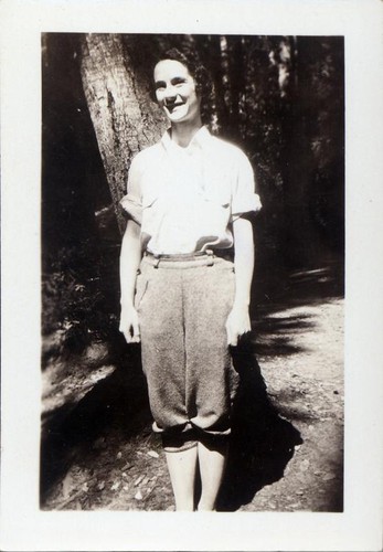 Women posing by a tree