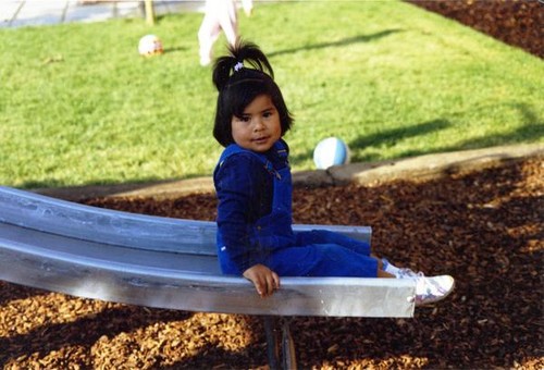 Girl sitting at the bottom of a slide