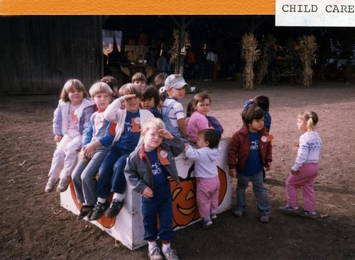 Children sitting on a wooden structure