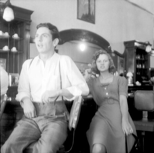 Man and women sitting at restaurant counter