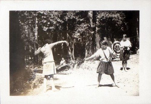 Two girls sword fighting in a forest