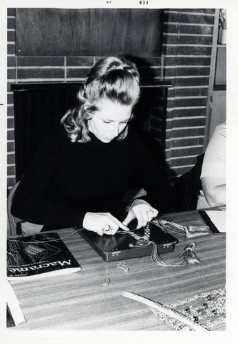 Woman working on a macrame project