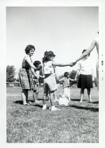 Young children and teenage girls playing