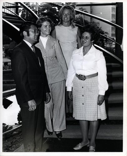 Three women posing with Mayor Norman Y. Mineta