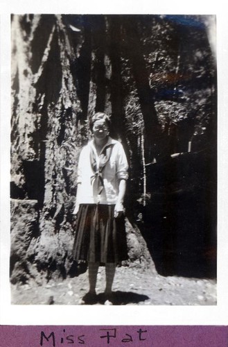 Miss Pat posing in front of a large redwood