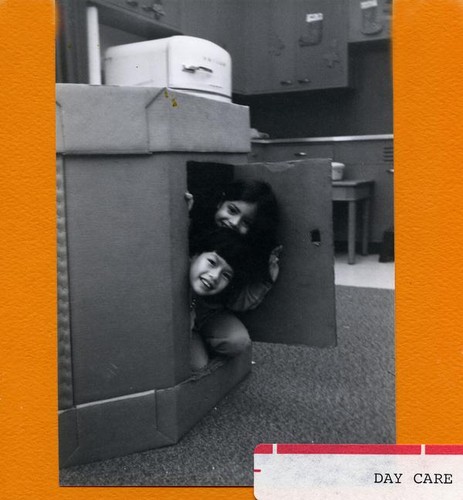 Two girls playing in a cardboard box