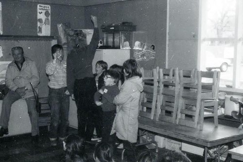 Children yelling and copying a woman's gestures