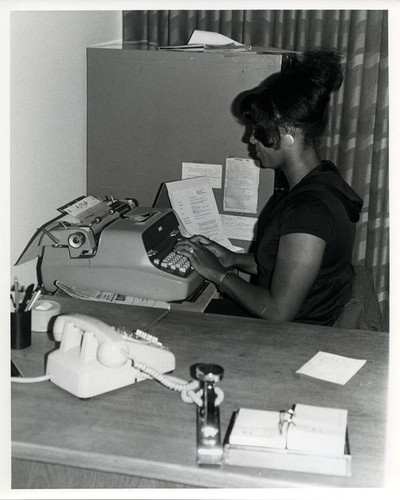 Woman typing on a typewriter