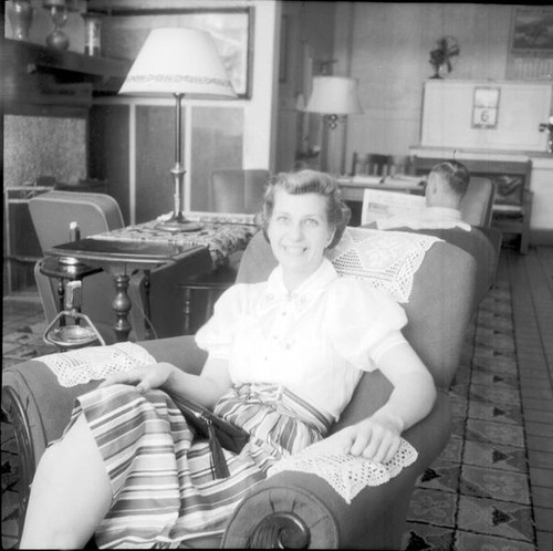 Unknown woman sitting in a parlor