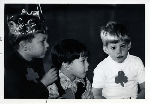 Three small boys sitting together