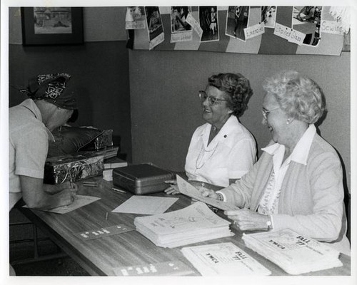 Two women passing out flyers