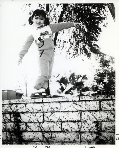 Girl balancing on a wall