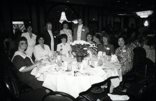 Women posing at a dining table