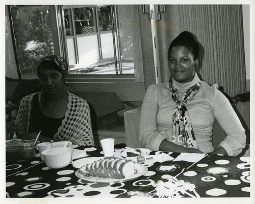 Two women sitting a table