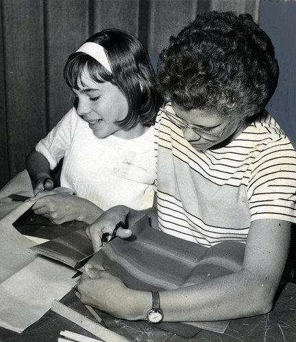 Debbie Pappain and Mary Jackson cutting out tissue paper squares