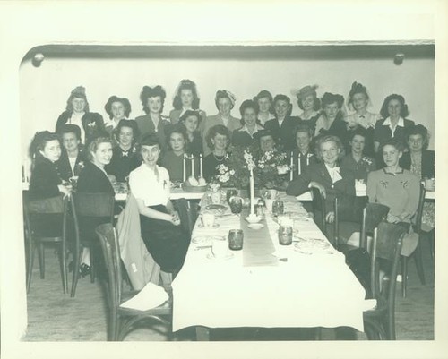 Group of women gathered around dining tables