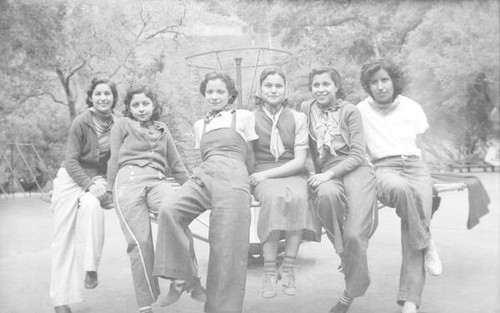 Group of teenage girls posing on playground equipment